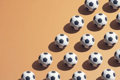 Footballs arranged in lines on an orange backdrop