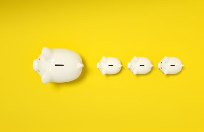 Top-down view of piggy banks on yellow background